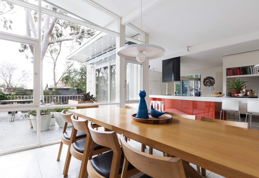 Scandinavian-styled dining room in open-plan kitchen with patio