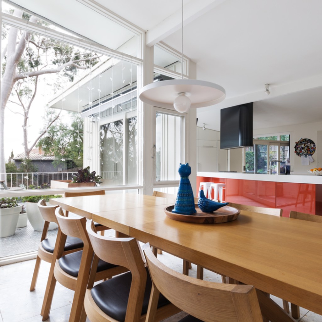 Scandinavian-styled dining room in open-plan kitchen with patio
