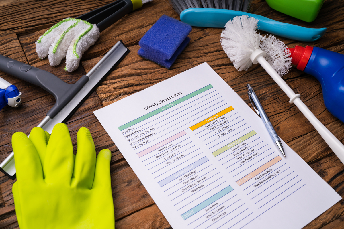 Cleaning supplies and checklist on a table