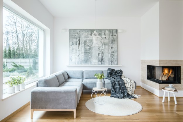 White sitting room interior with gray corner sofa
