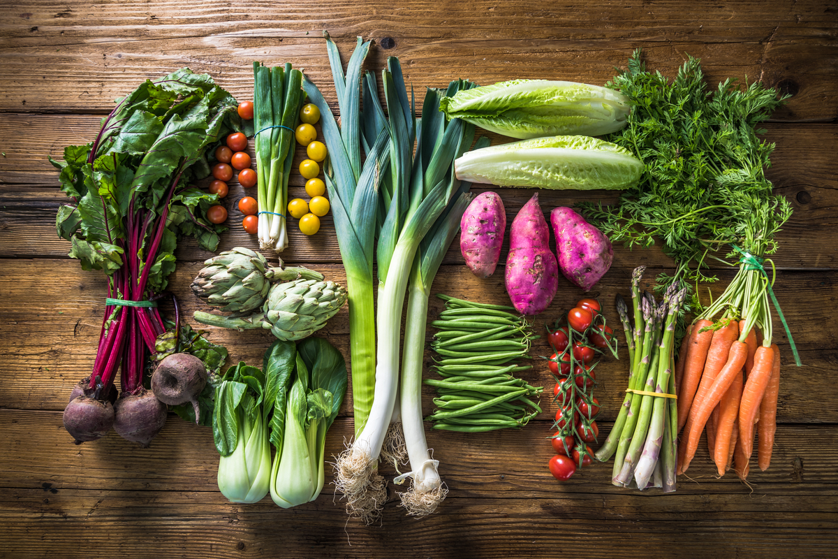 Assorged fresh vegetables on a wood surface