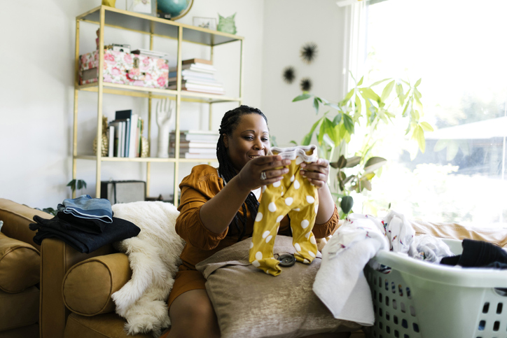 Woman folding laundry in living room