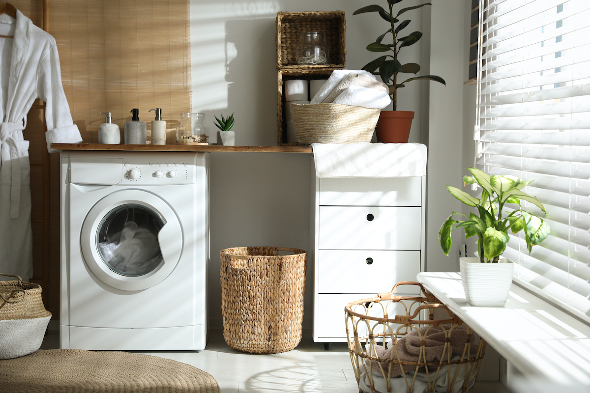 Bathroom with storage baskets, drawers, and a washing machine
