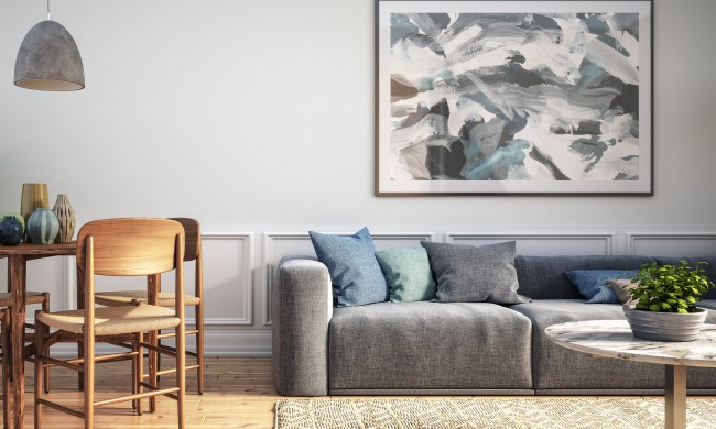 Living area with abstract art hanging over the couch