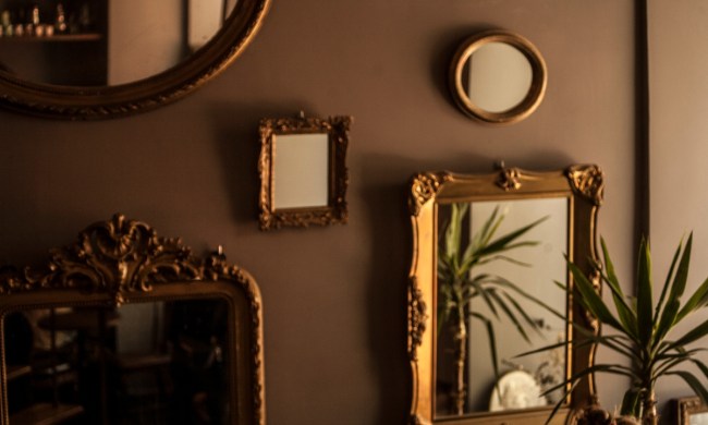 Multiple antique mirrors on gallery wall