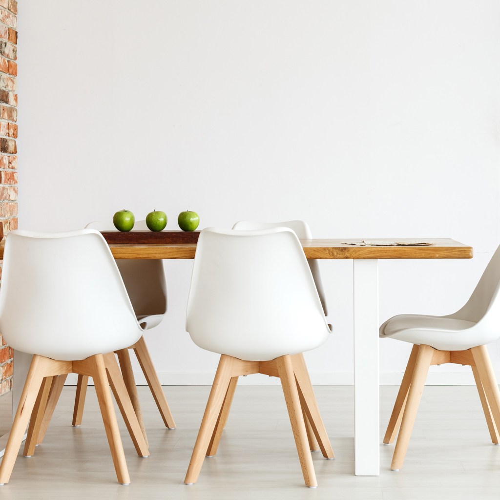 Modern dining table pushed against a wall