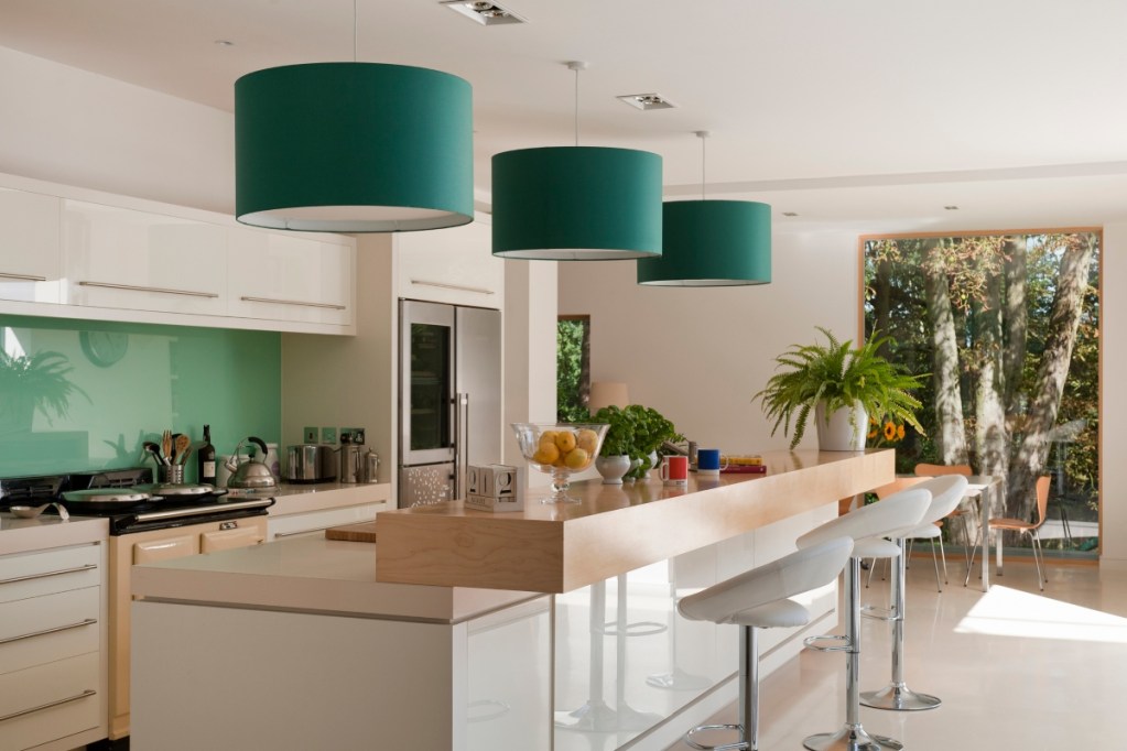 Green round pendant drum lights above kitchen island