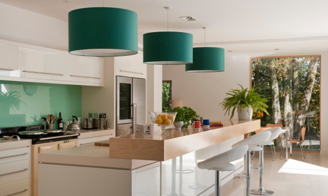 Green round pendant drum lights above kitchen island