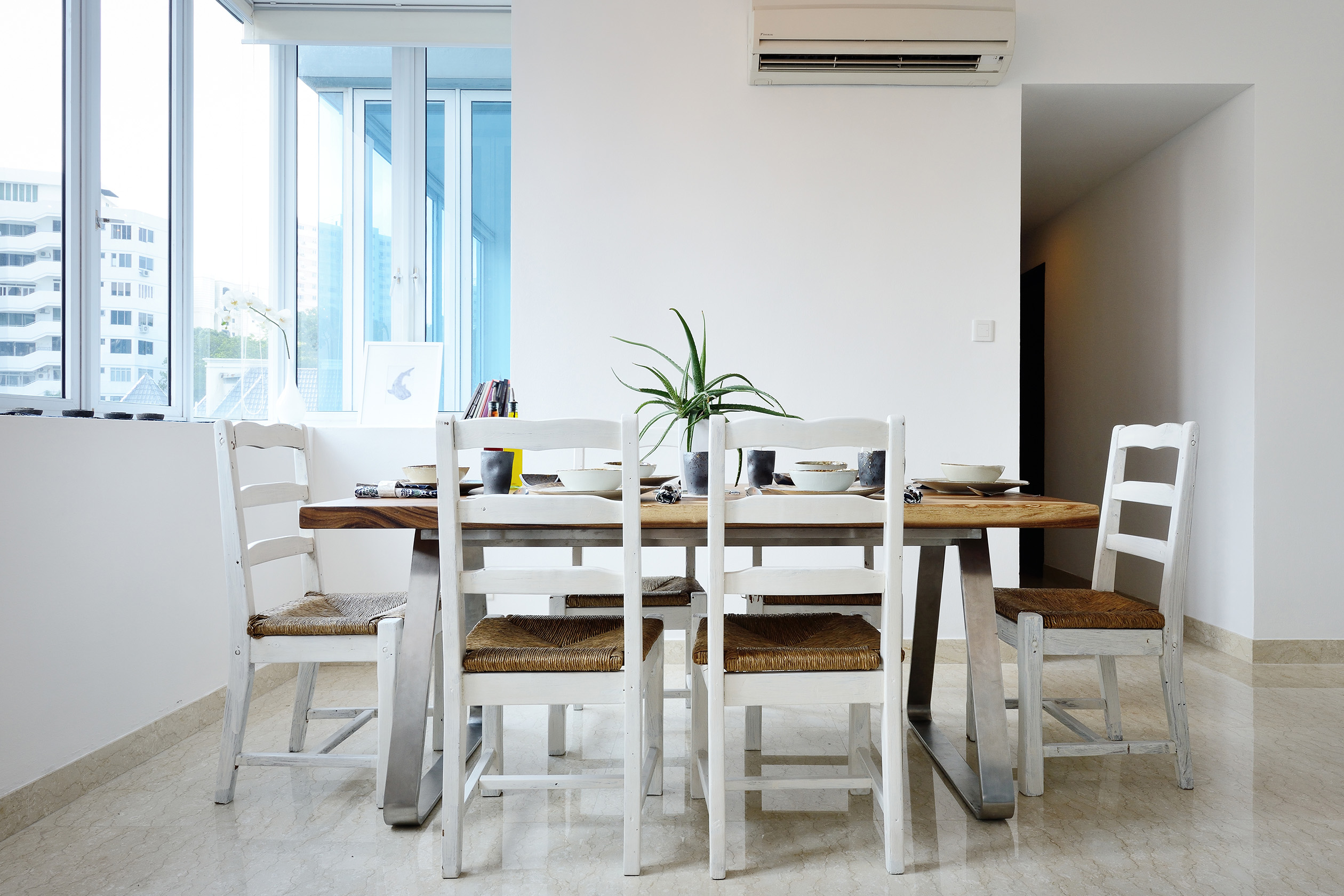 Small, white dining room with natural light