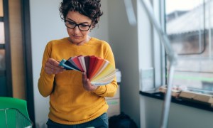 Woman holding paint color swatches