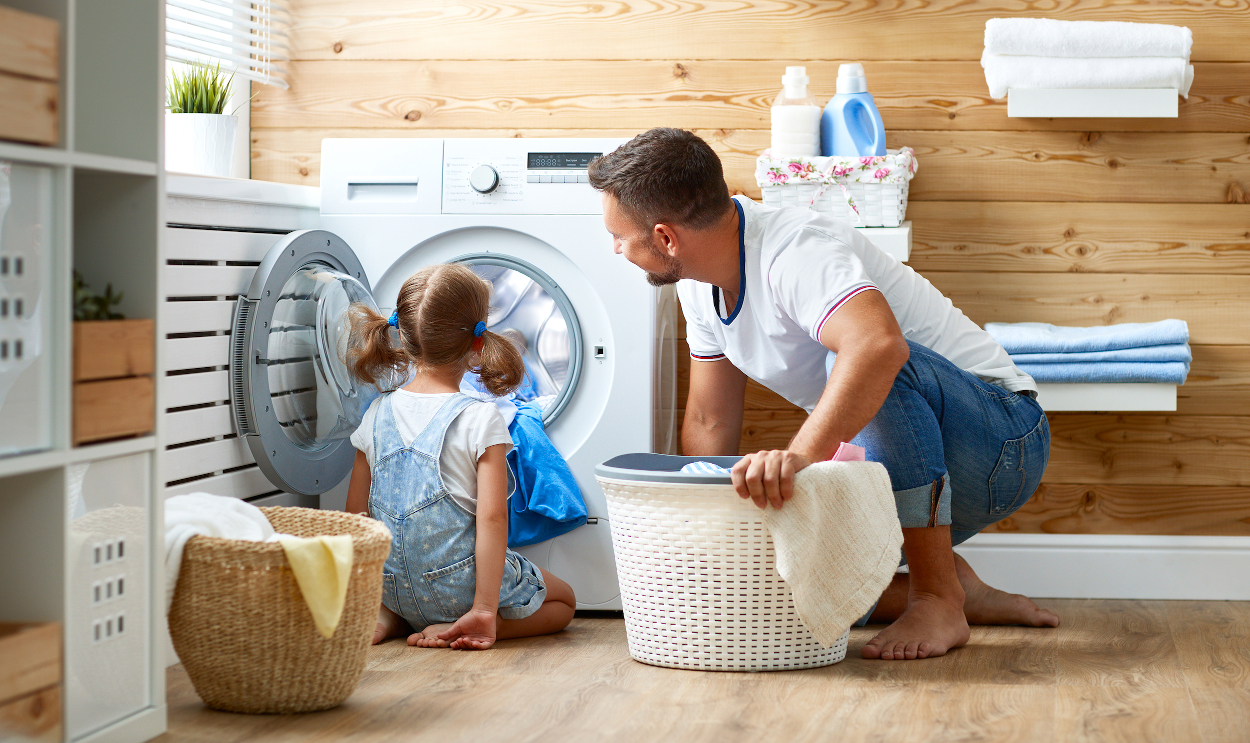 Father and daughter doing laundry