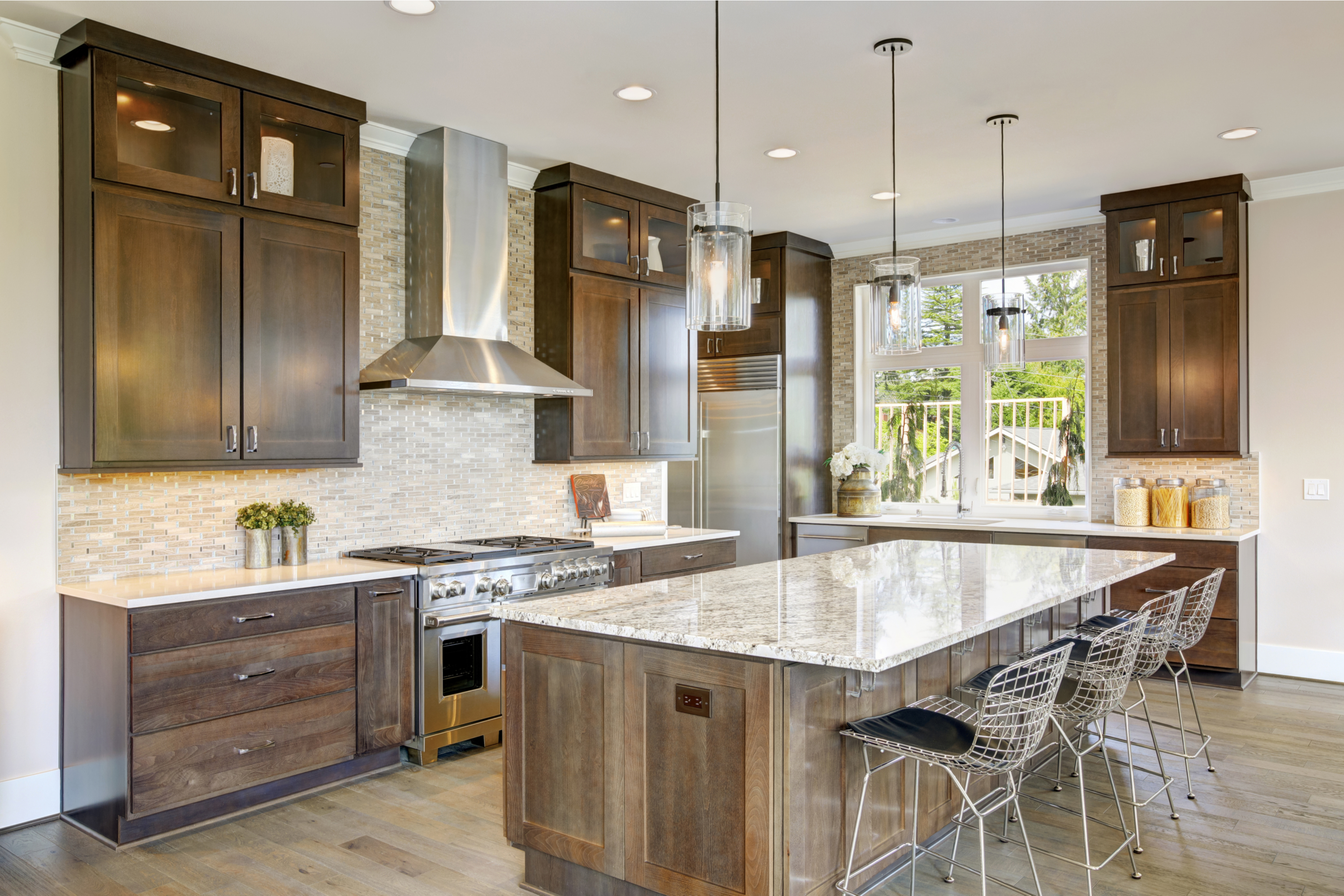 high ceiling kitchen with backsplash and wood cabinets