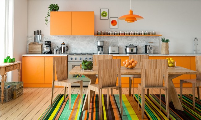 Orange and wood kitchen cabinets in brightly colored kitchen