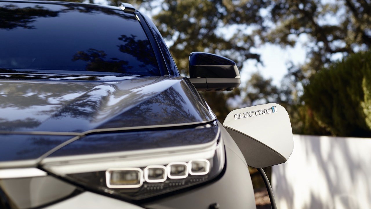 detail of the fron headlights cluster of a Toyota bZ4x being charged.
