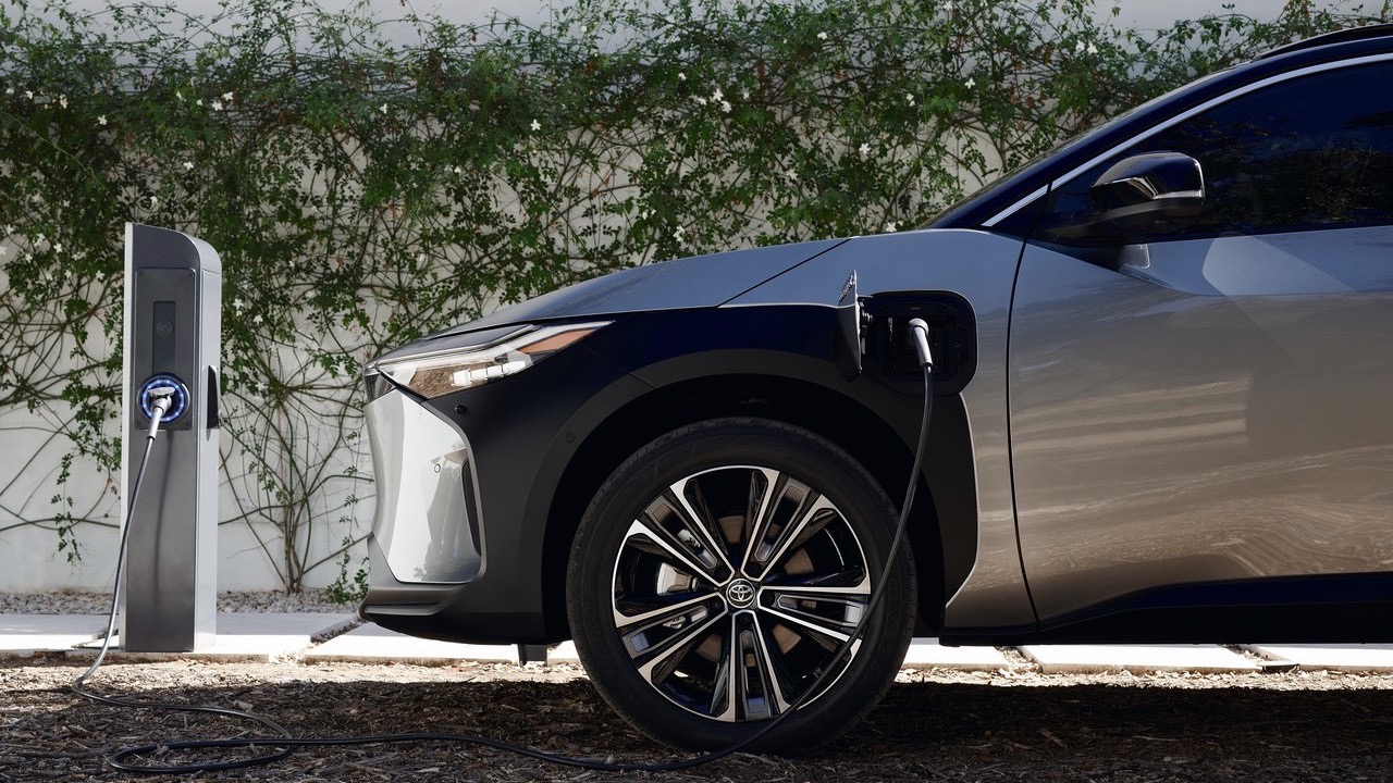 Toyota bZ4x front end side view being charged.