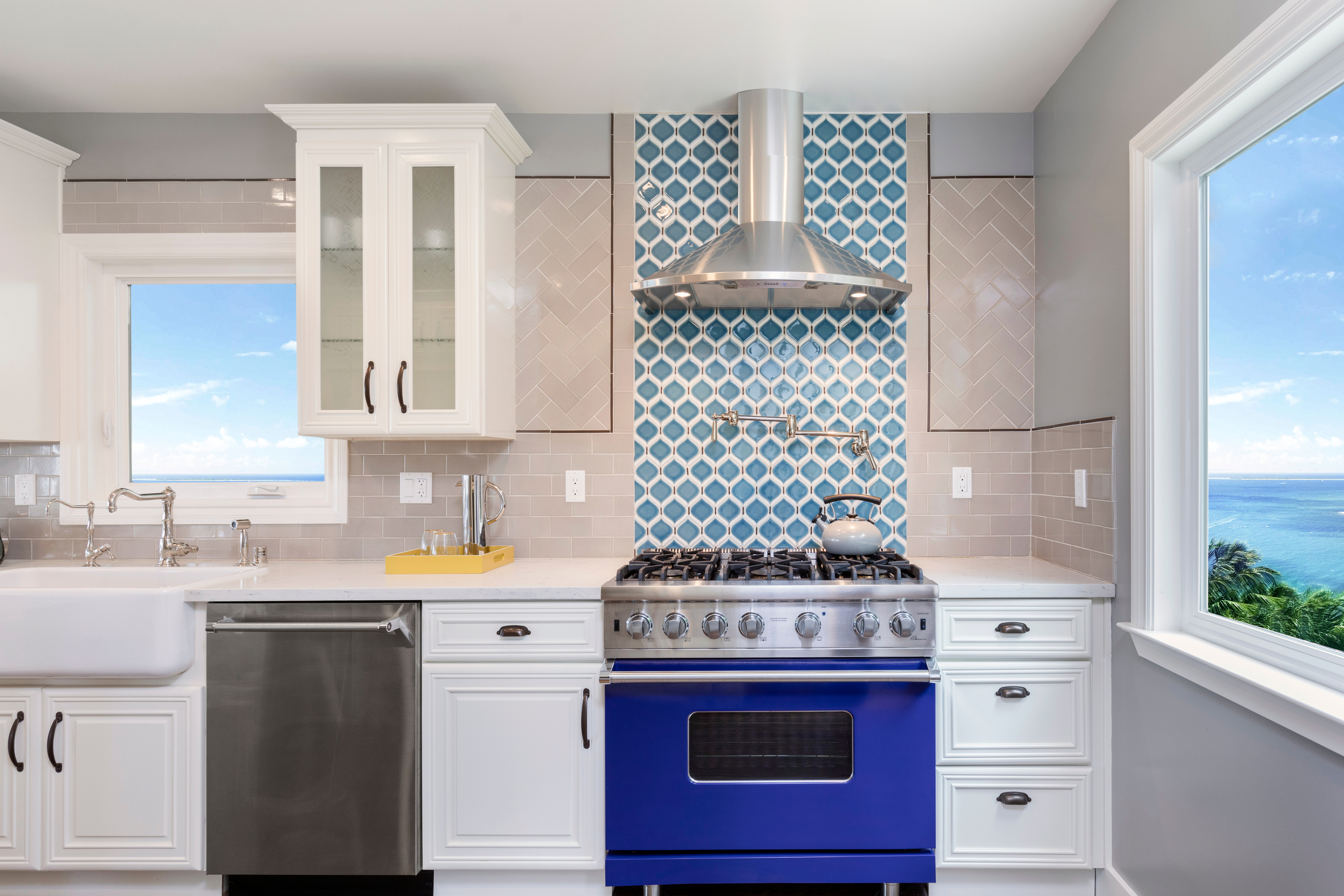 blue stove in white modern coastal kitchen