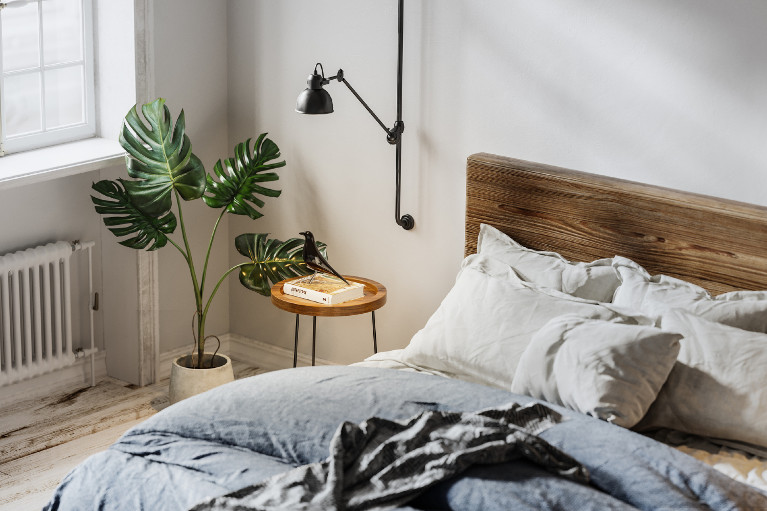 Comfortable bedroom with plant, lamp, and bed.
