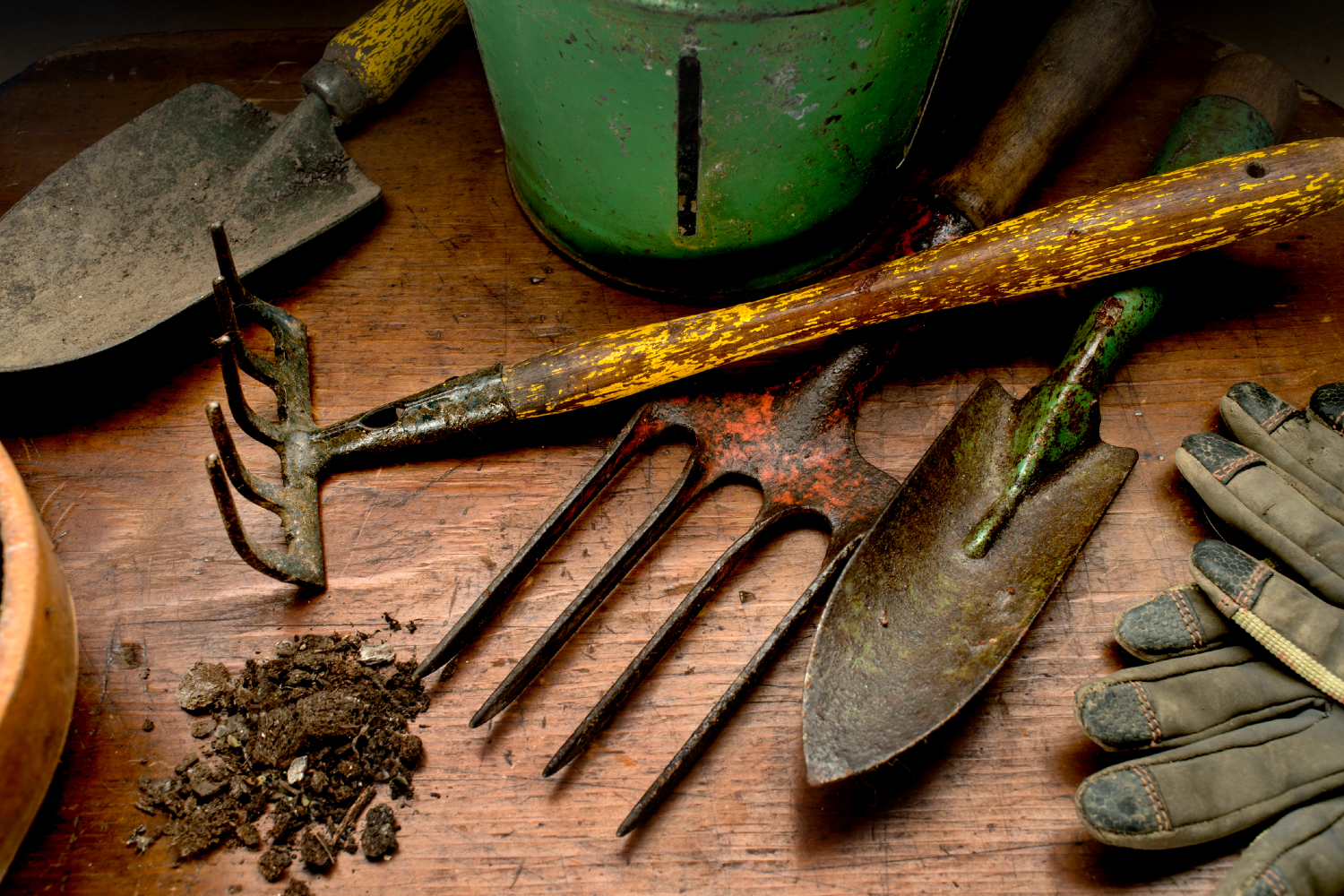 Dirty garden tools on work bench with dirt