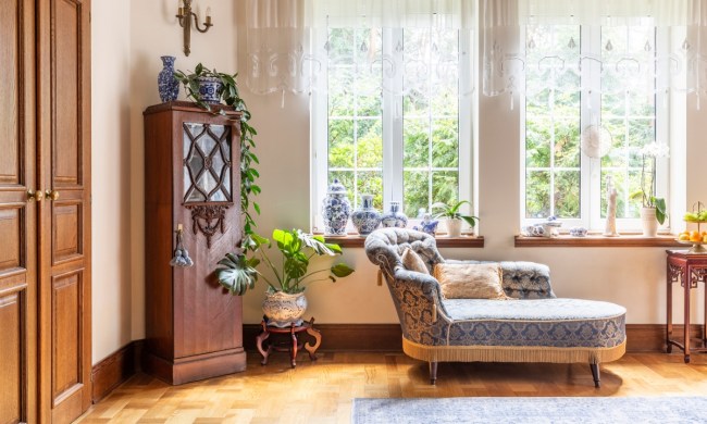 Vintage decor with grandmillenial chaise lounge and traditional cabinet