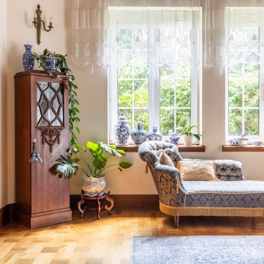 Vintage decor with grandmillenial chaise lounge and traditional cabinet