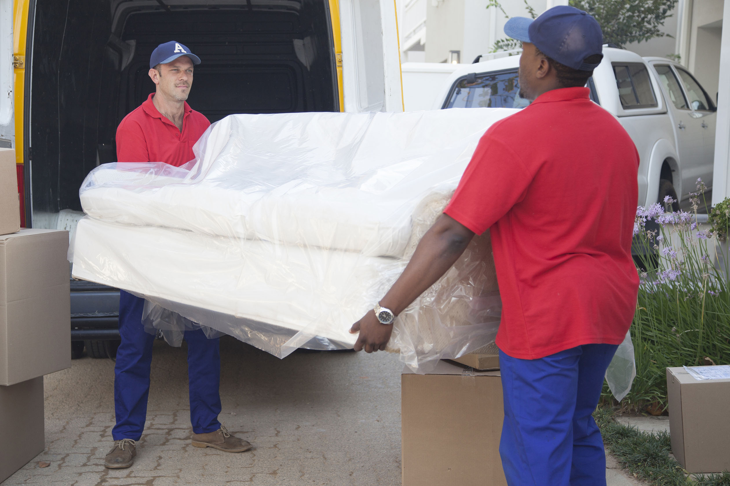 Movers carrying a white couch
