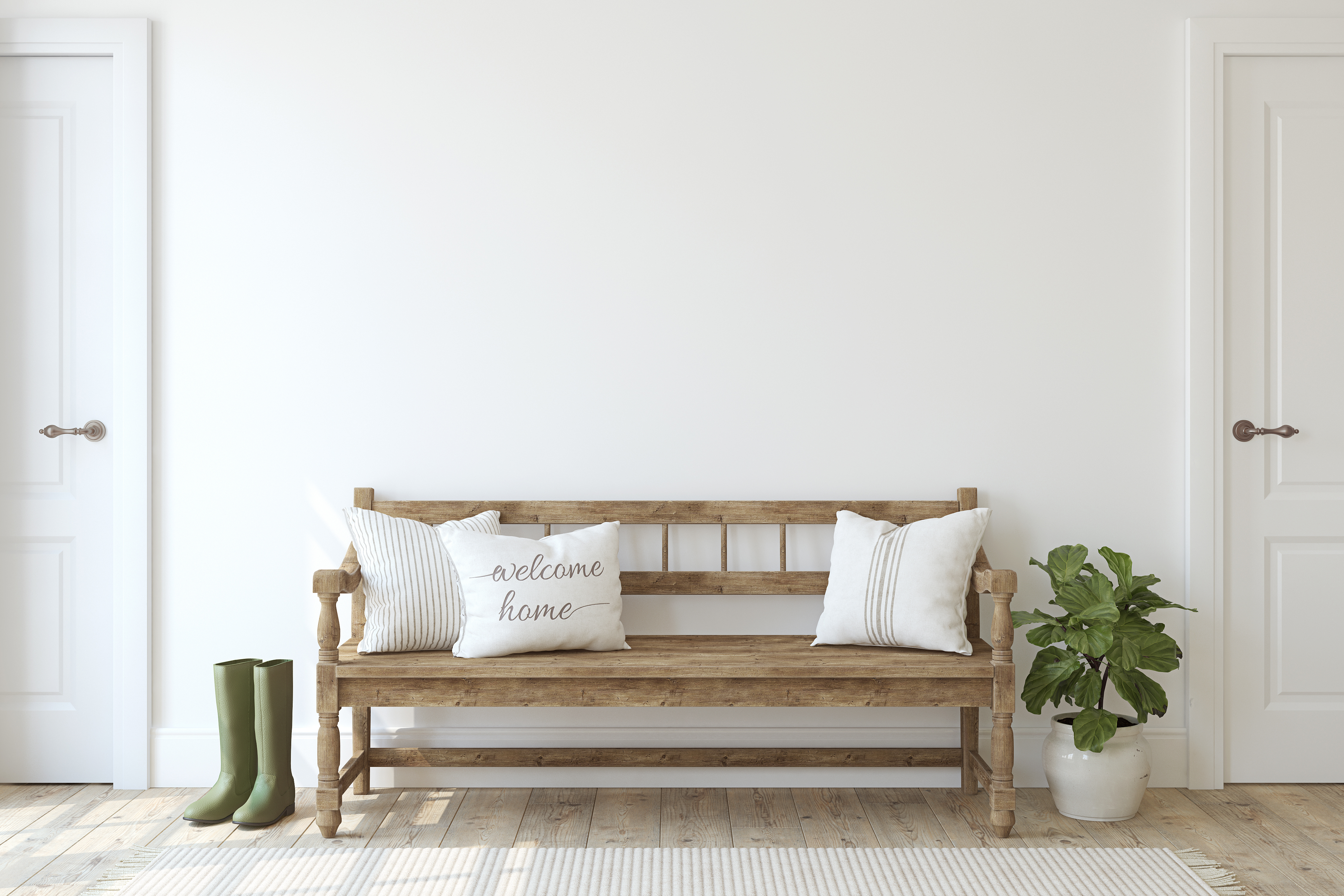 Bare white wall with wood bench in front.