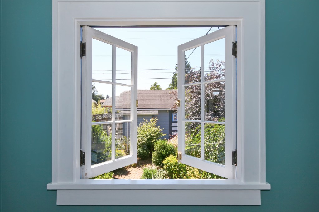 Window with trim on a teal wall