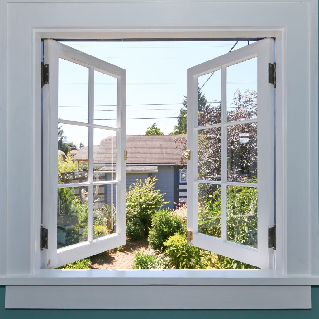 Window with trim on a teal wall