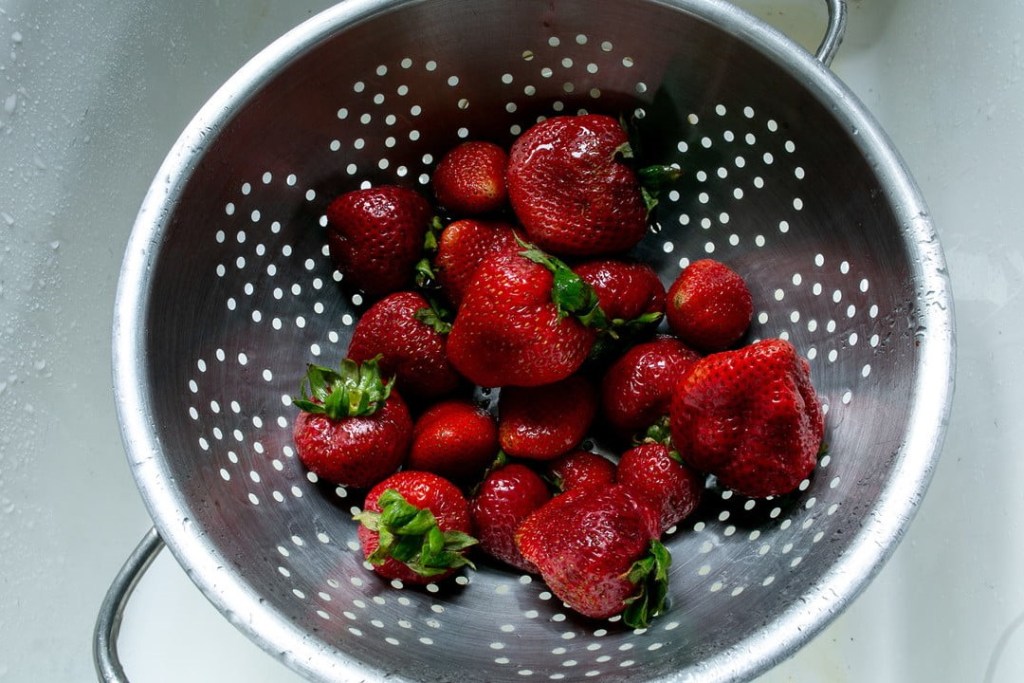 Strawberries in a metal strainer