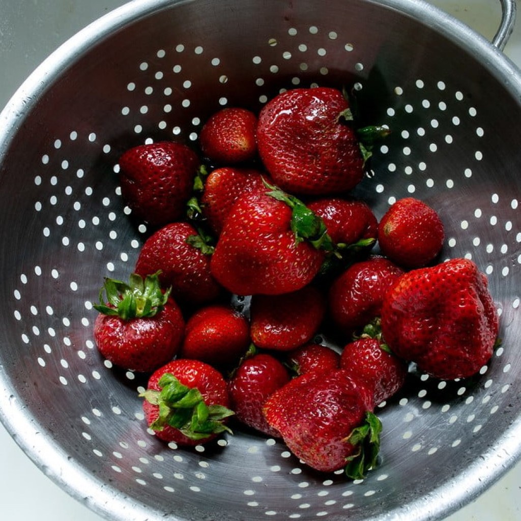 Strawberries in a metal strainer