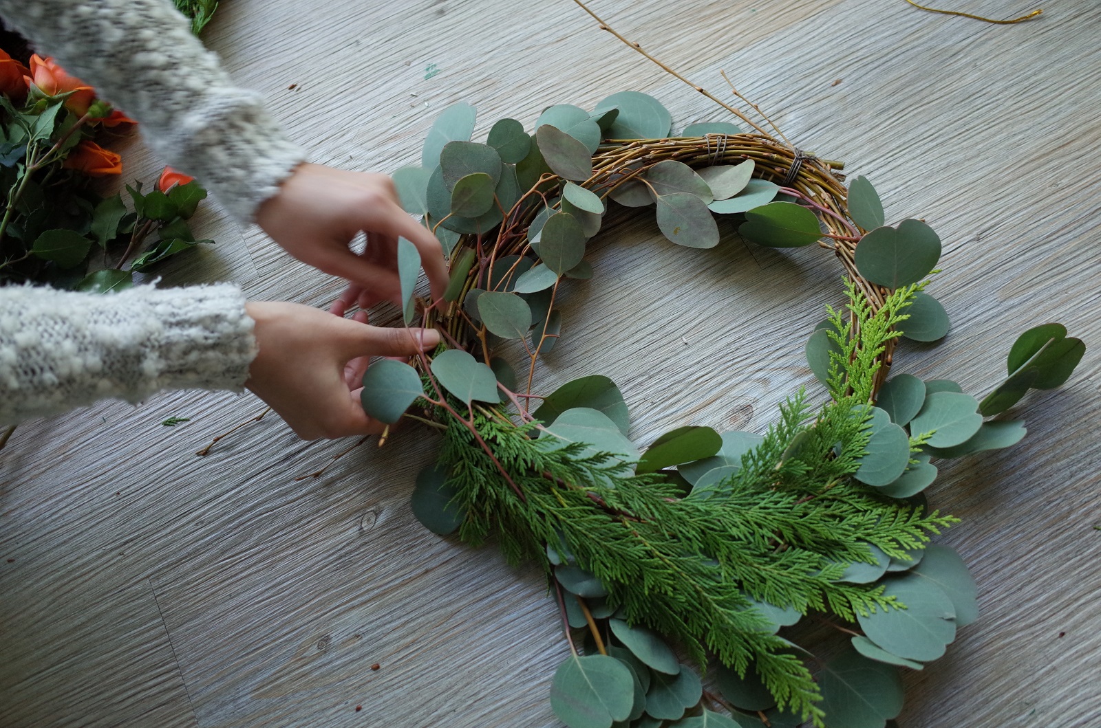 Person hand making a wreath
