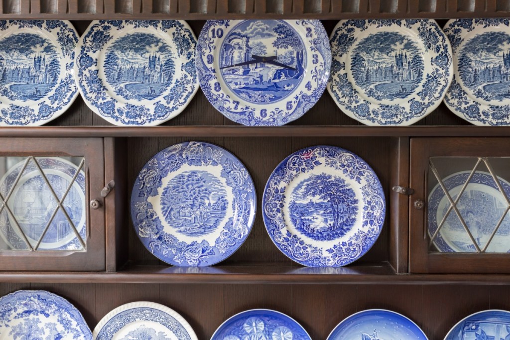 China cabinet with blue and white ceramic plates on display
