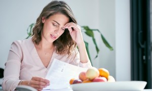 Financially anxious woman looking at paperwork
