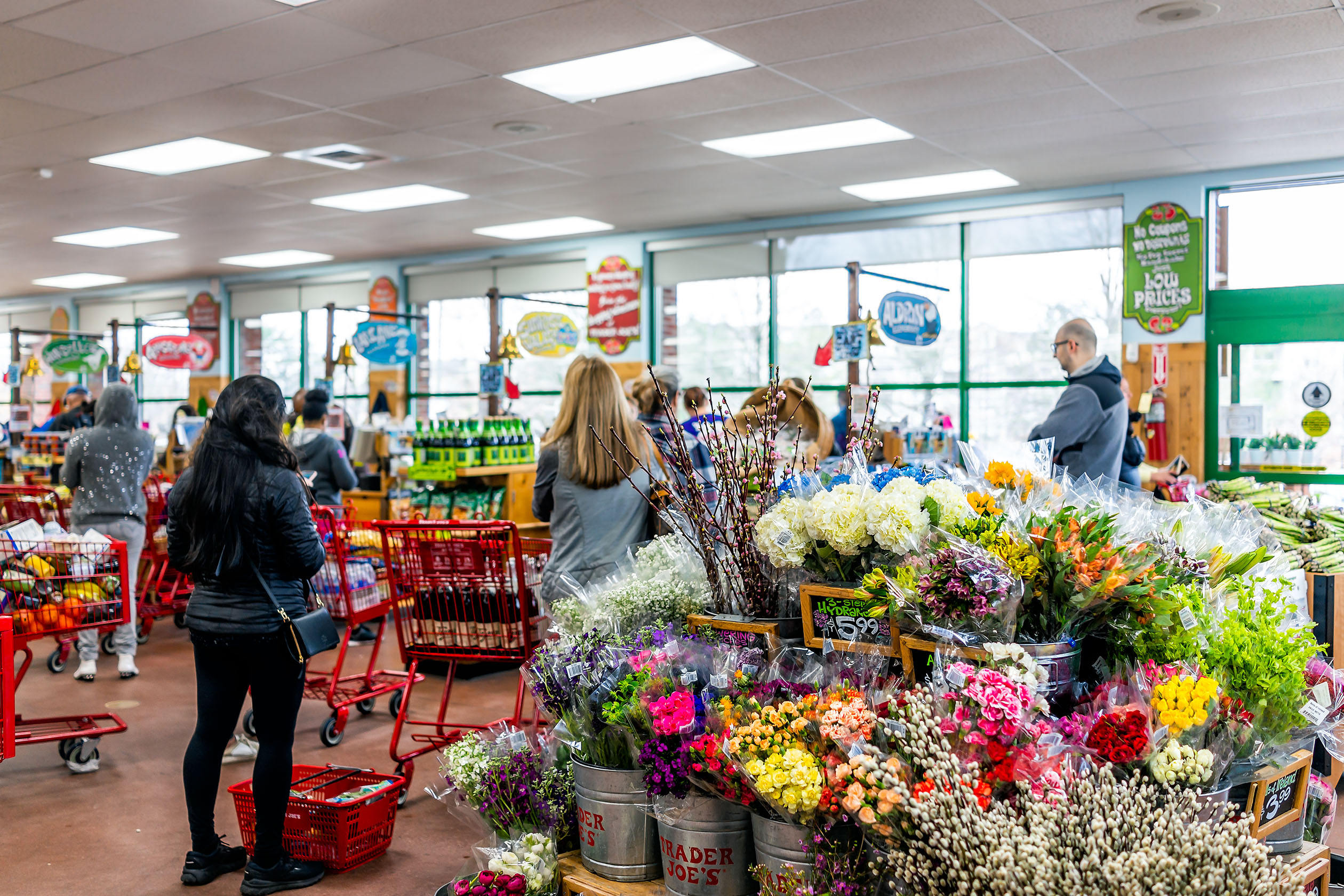 Flowers near a crowded Trader Joe's checkout
