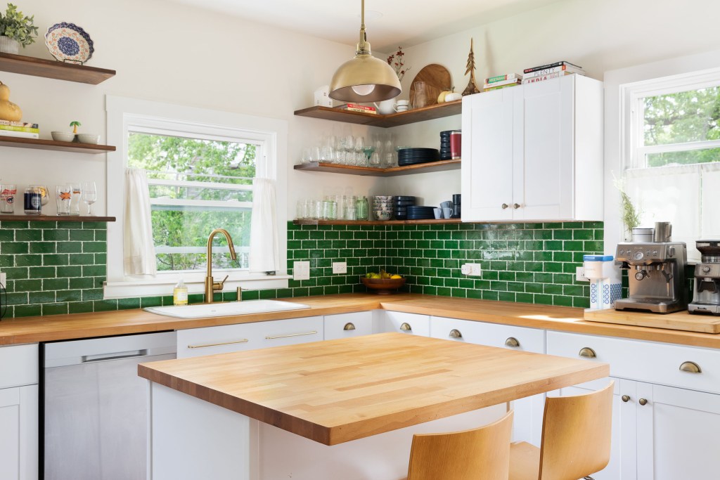 Kitchen with a green tile backsplash