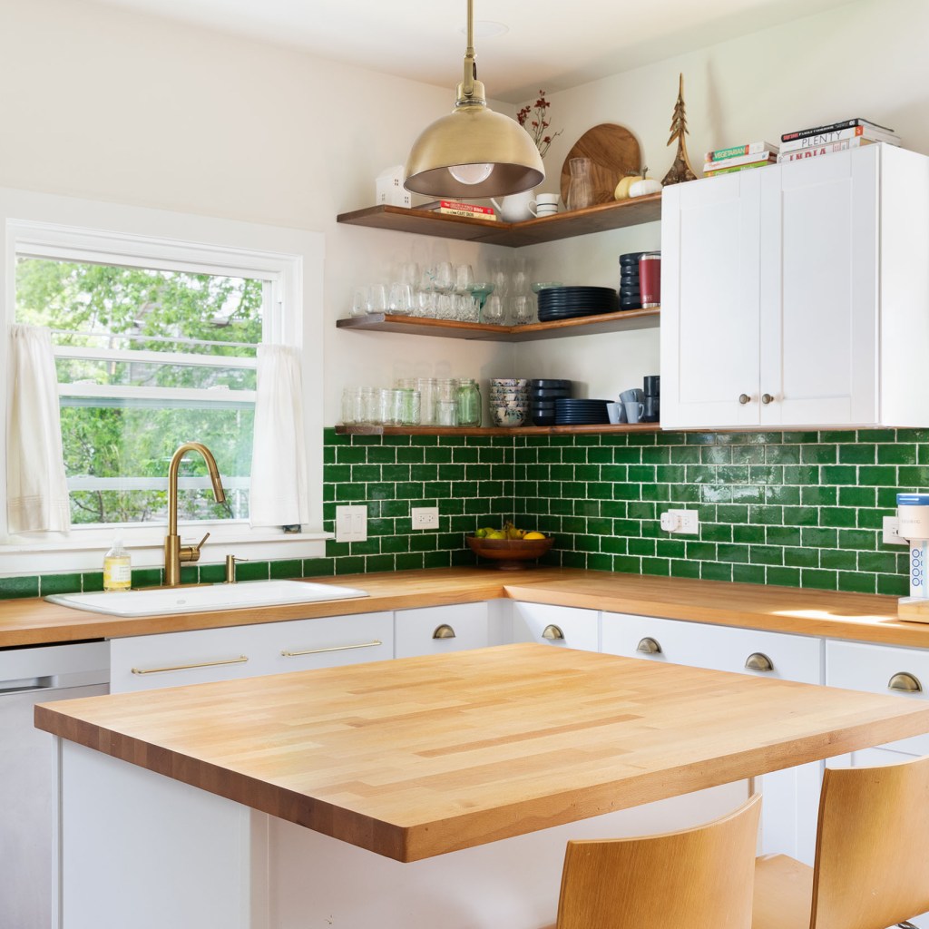 Kitchen with a green tile backsplash