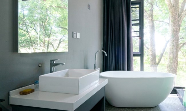 Modern black and white bathroom with large tub