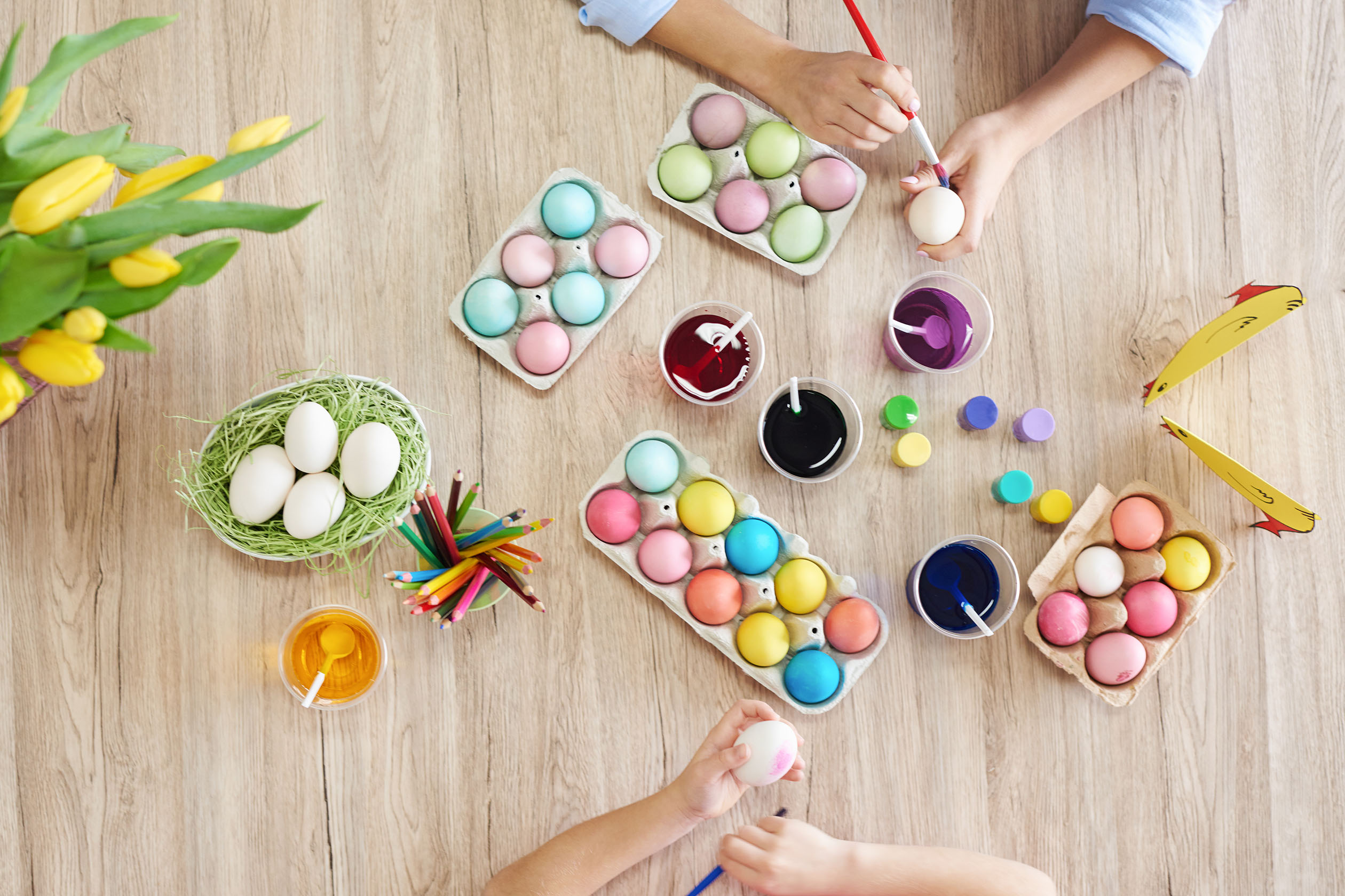Mother and daughter painting Easter eggs