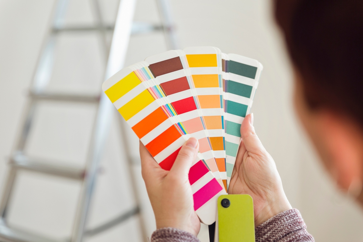 person holding color swatches