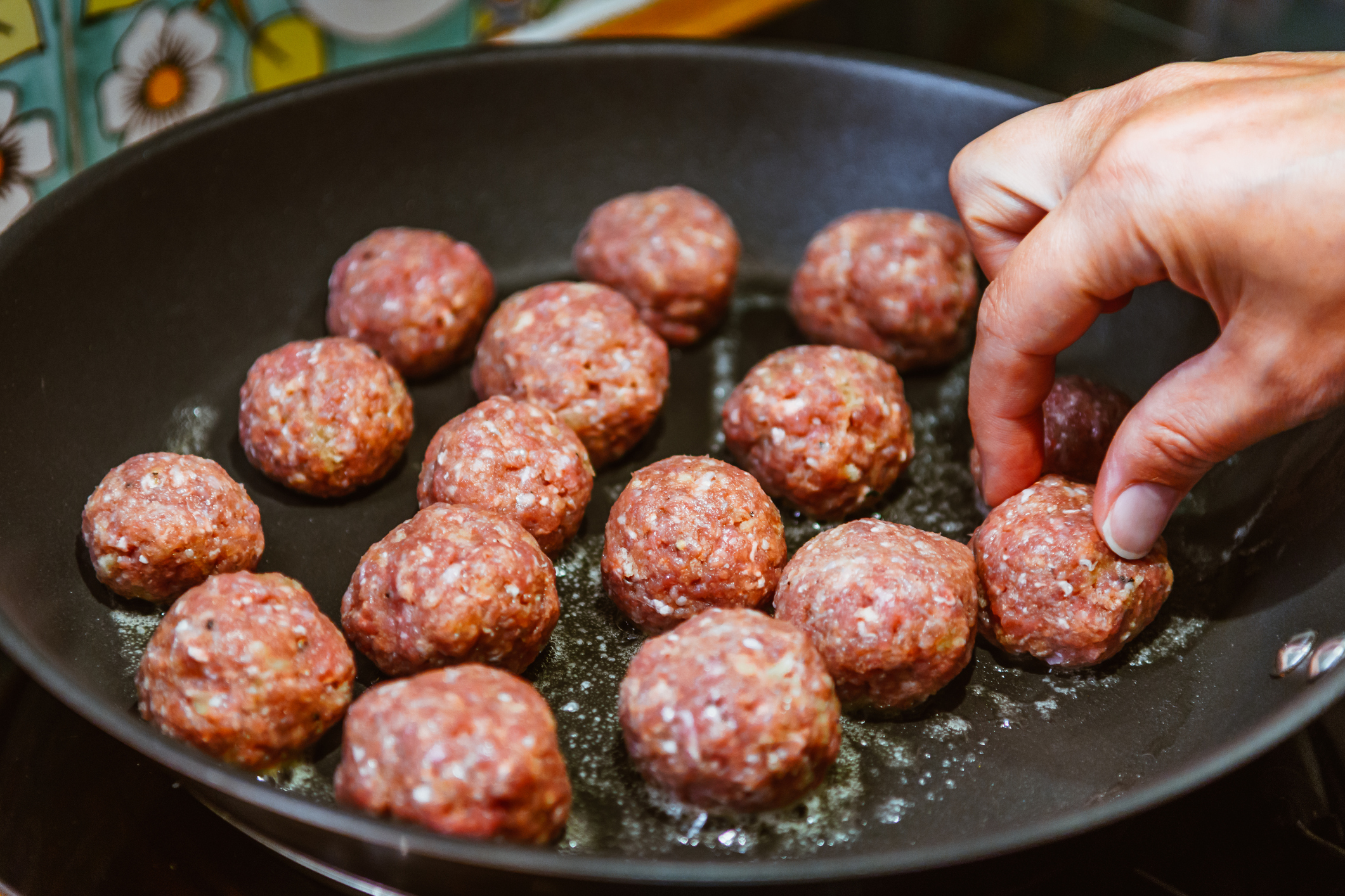 Cooking homemade meatballs in a pan