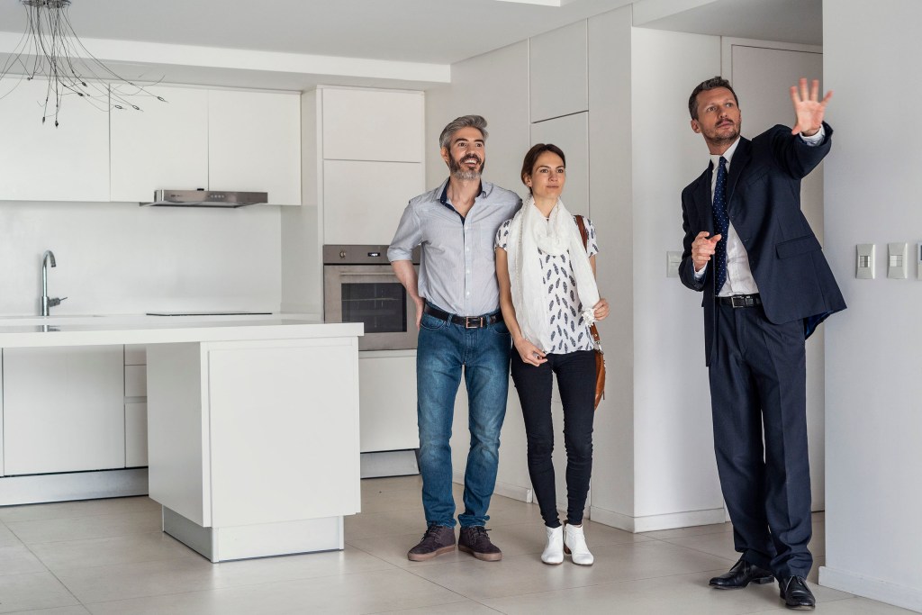 Realtor showing a couple a home