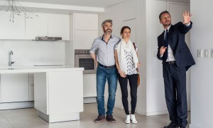Realtor showing a couple a home
