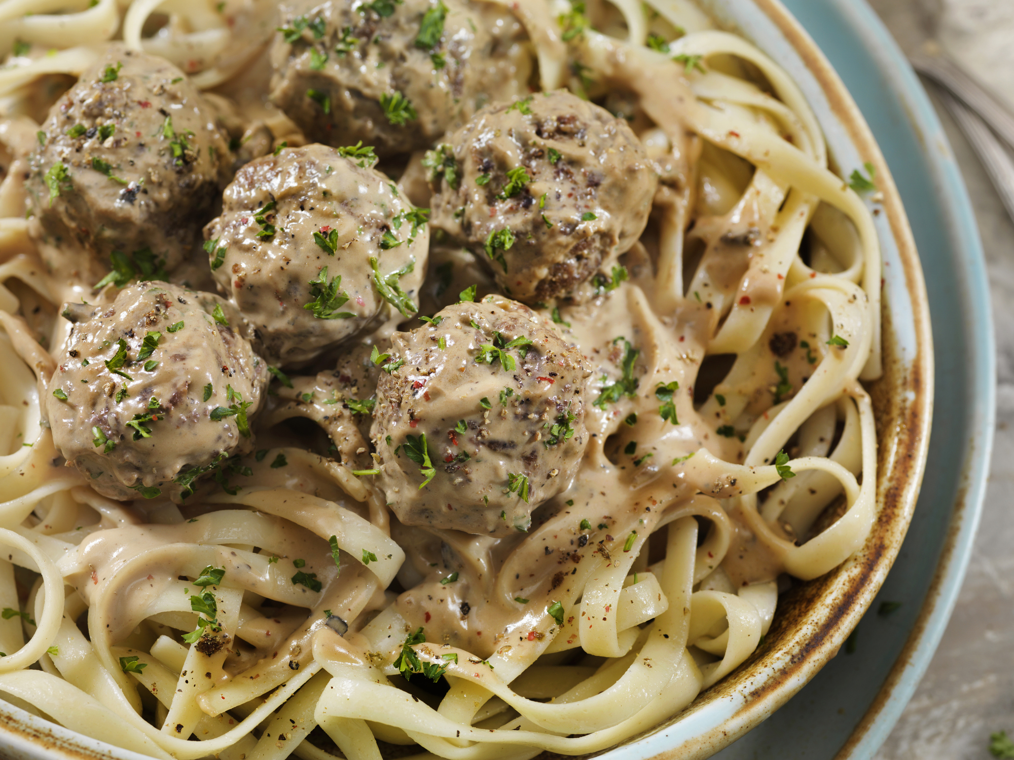 Swedish meatballs on linguini noodles with parsley garnish