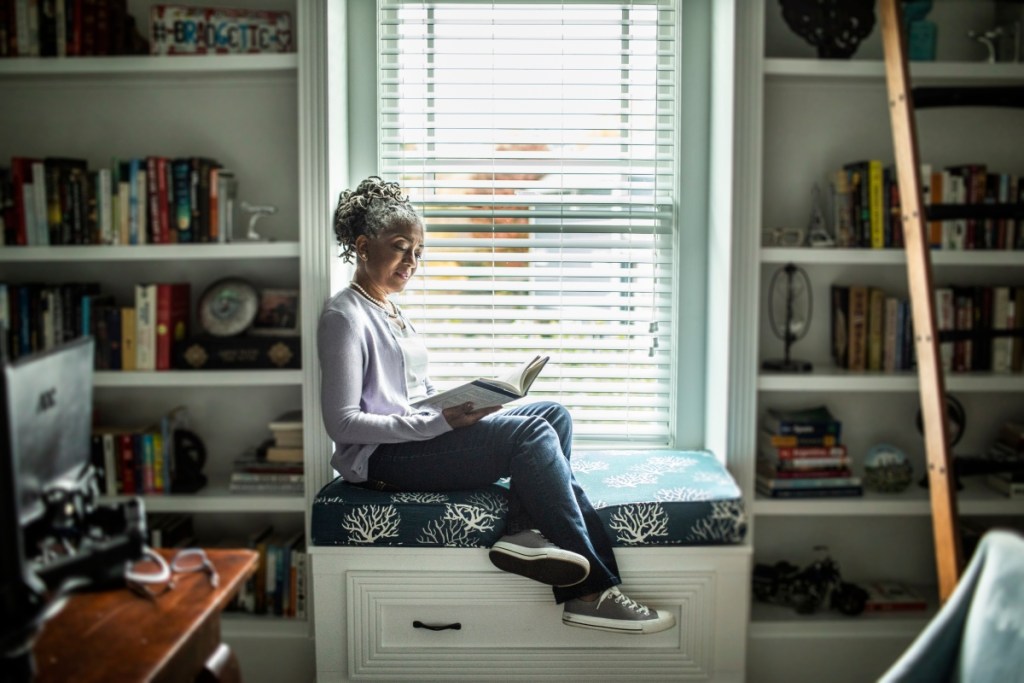 Woman reading in personal home library