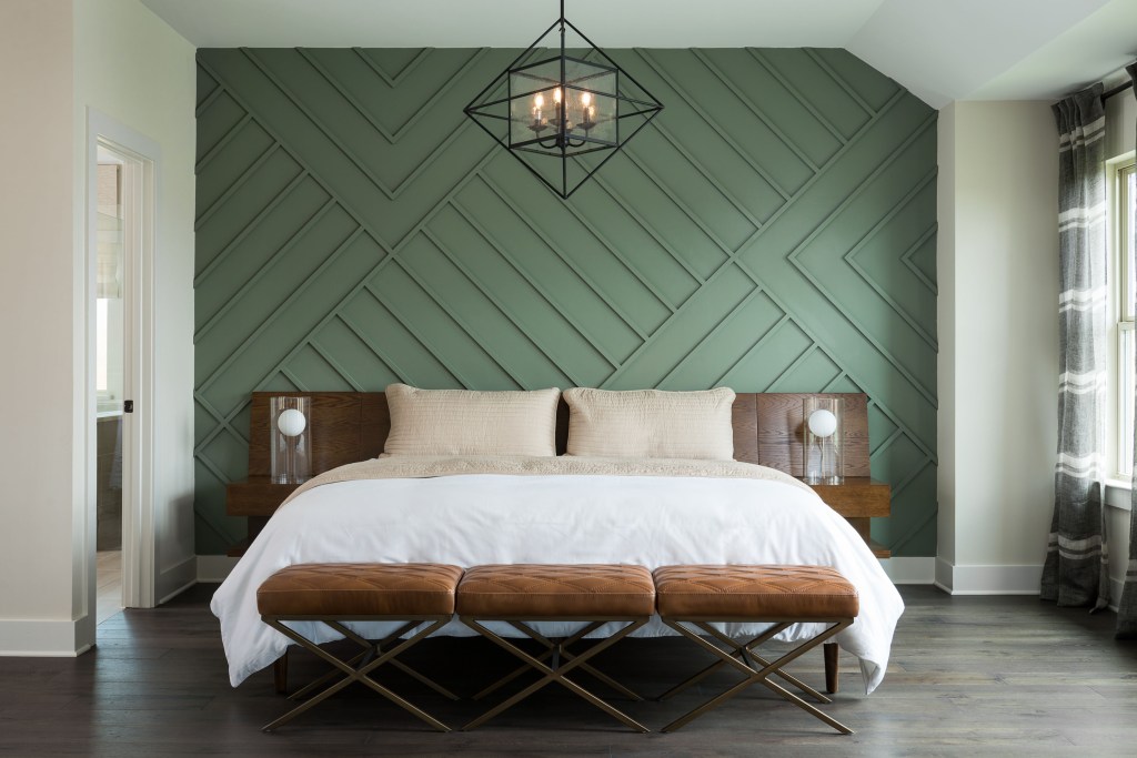 Bedroom with green wood panel accent wall