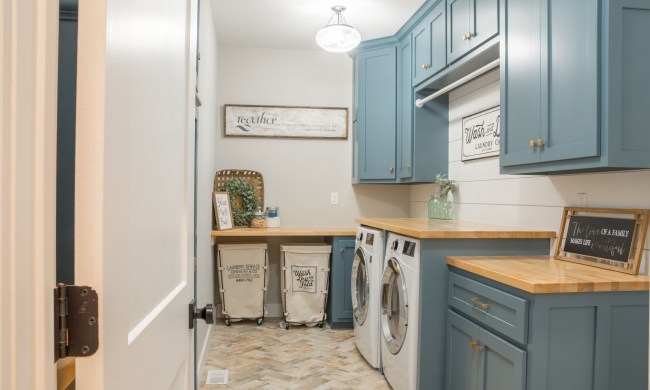 Farmhouse style laundry room with blue cabinets