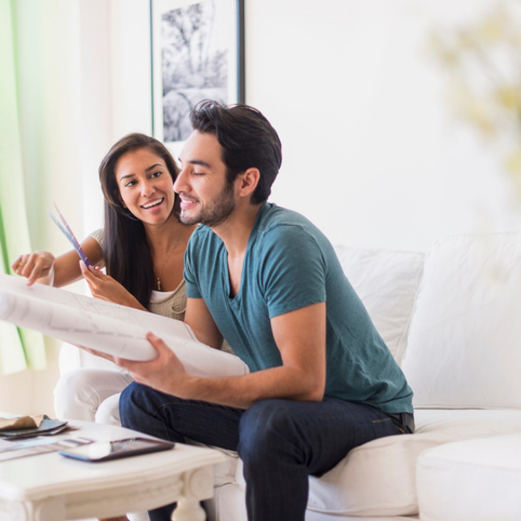 Couple sitting on sofa in living room