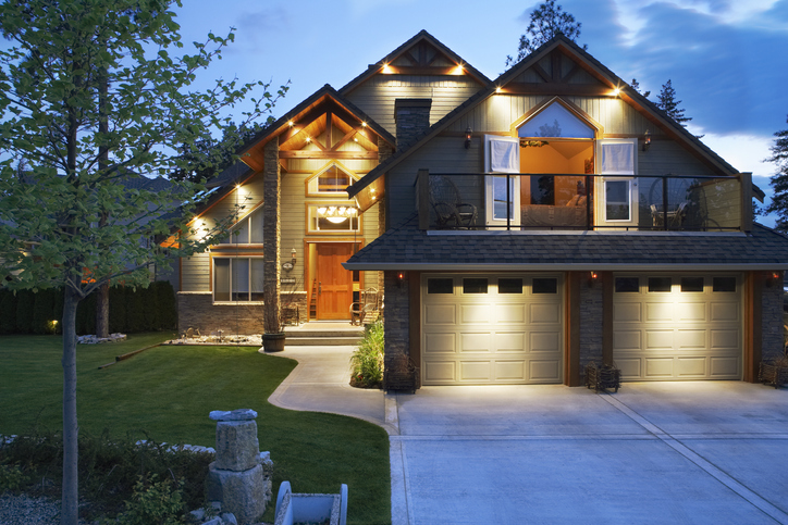 gray house exterior at dusk with night lighting