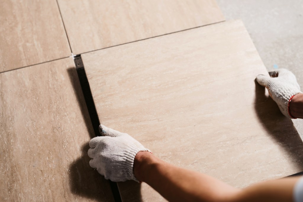 man laying flooring