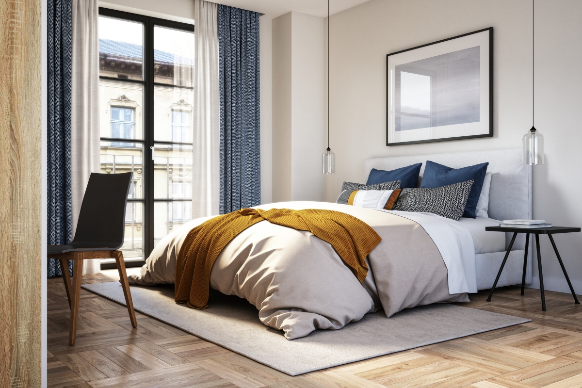 modern bedroom with tall curtains and colorful blanket